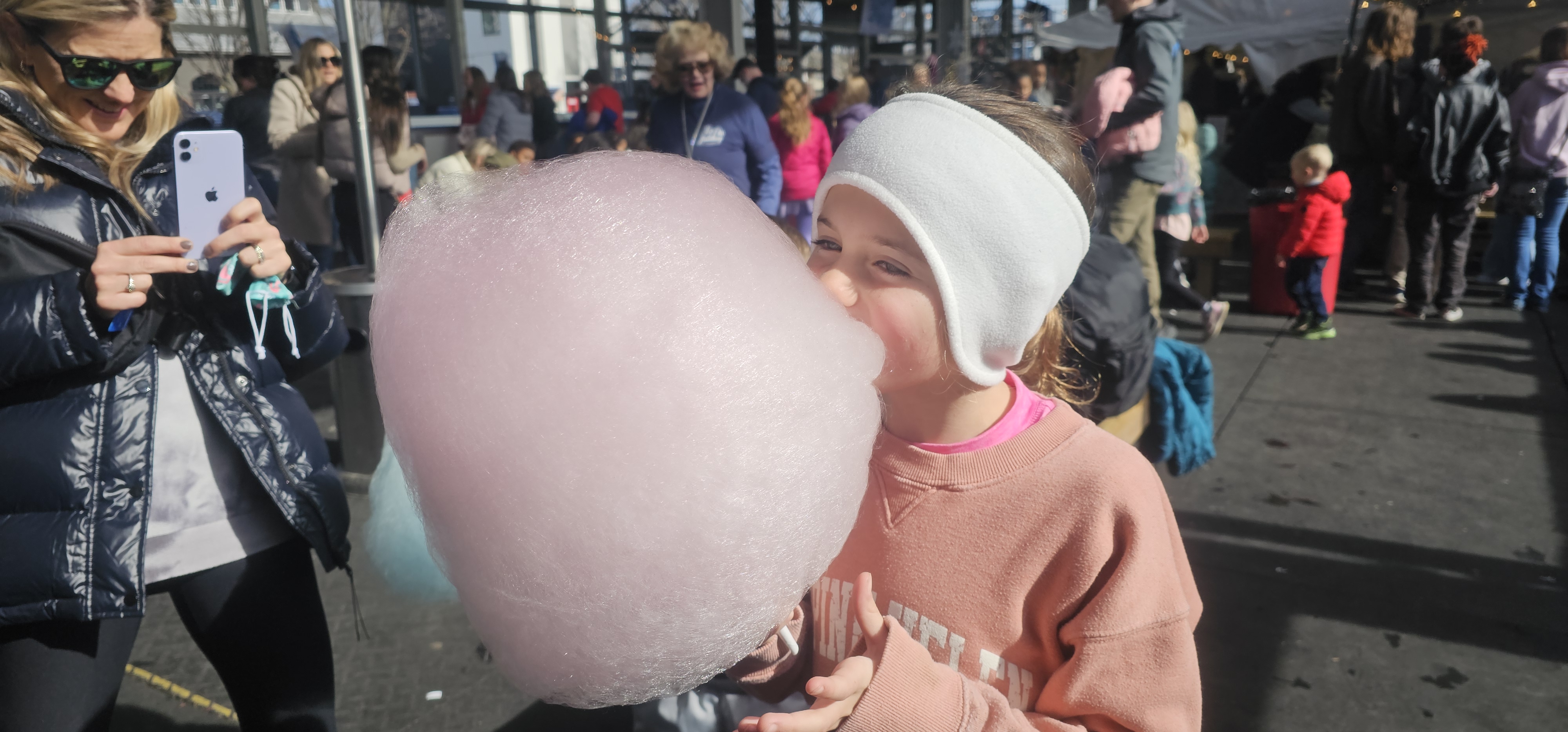 Family enjoying cotton candy at Ice on the Landing