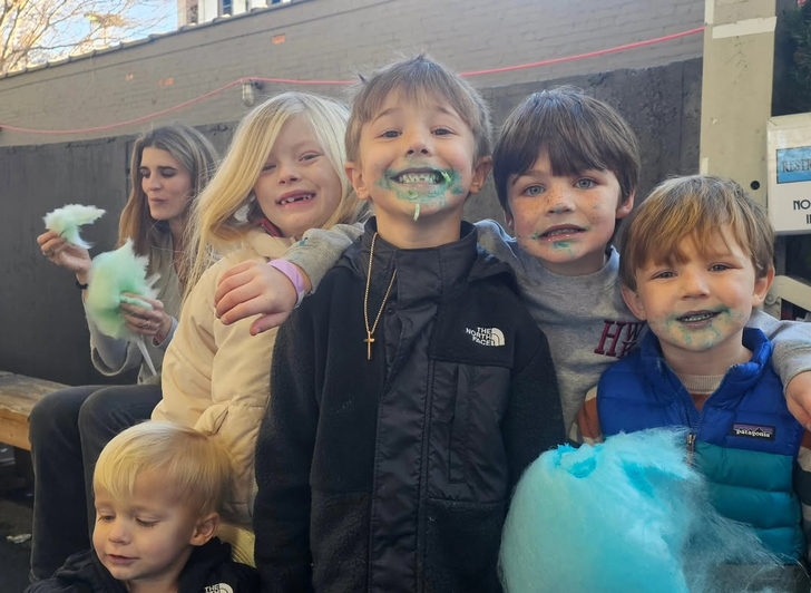 Five kids with cotton candy at a community event