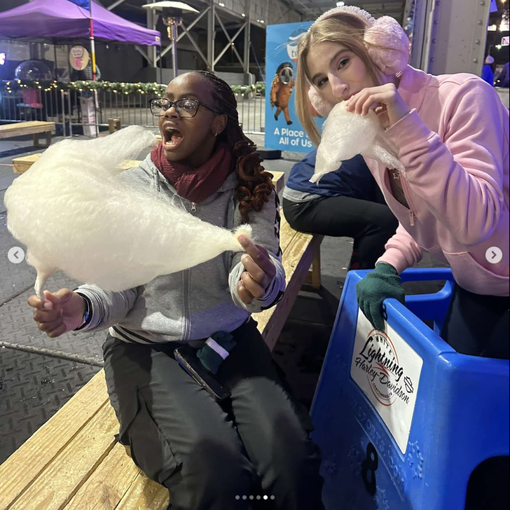 Two friends with cotton candy at Ice on the Landing